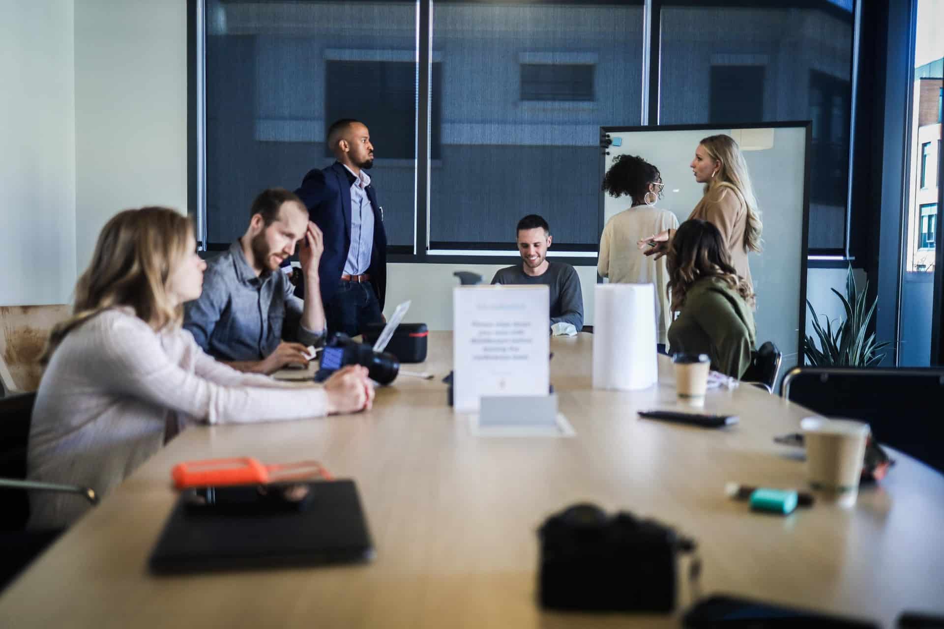 People sitting at table during strategy session or business meeting